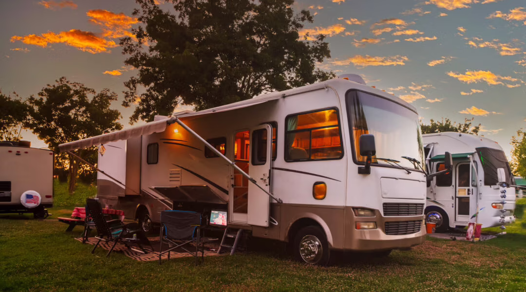 Sun going down at the Rv park with lights on the motor home